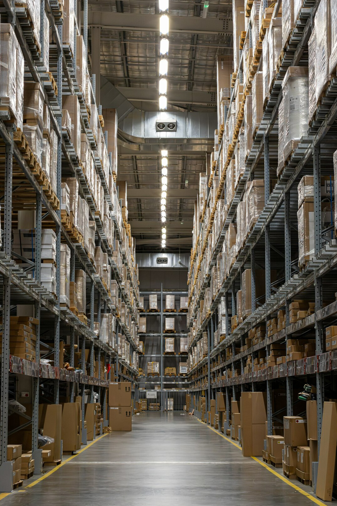 Warehouse interior with forklift moving pallets